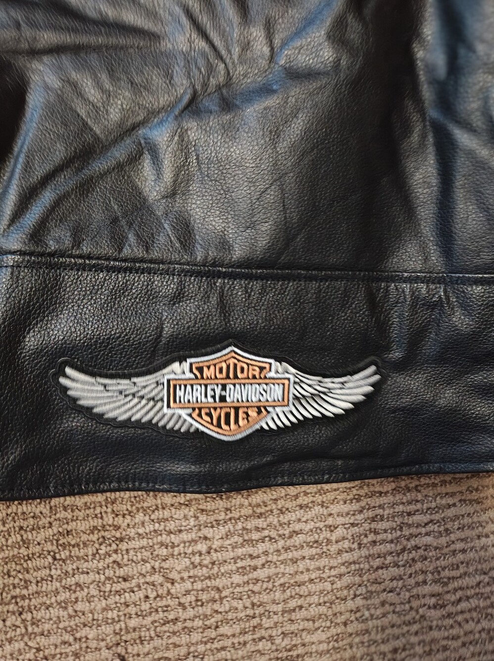 Men's Black Leather Bomber Jacket with Winged Logo Patch and comes with armor